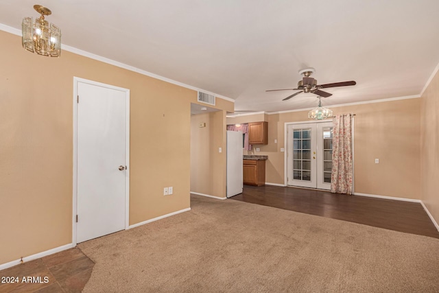 unfurnished living room with ceiling fan, dark hardwood / wood-style flooring, french doors, and ornamental molding