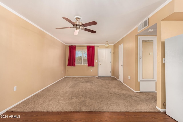 spare room featuring hardwood / wood-style flooring, ceiling fan, and ornamental molding