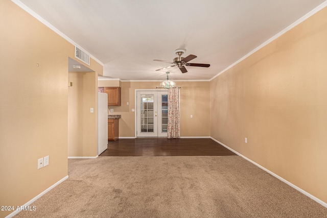 unfurnished living room featuring ceiling fan, dark carpet, crown molding, and french doors