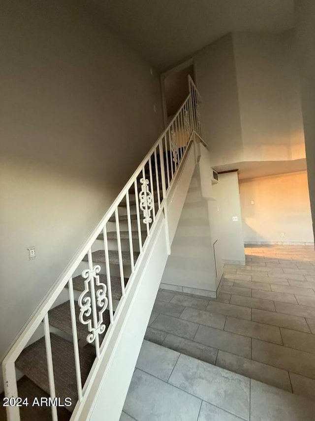 staircase featuring tile patterned floors