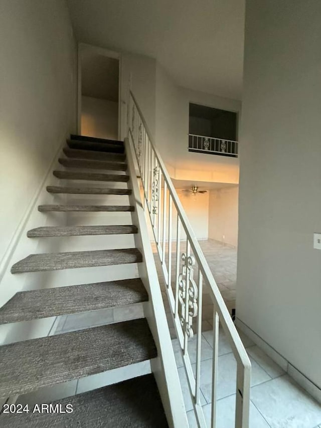 staircase featuring tile patterned floors