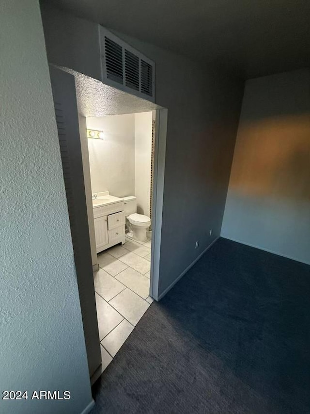 bathroom with tile patterned floors, vanity, and toilet