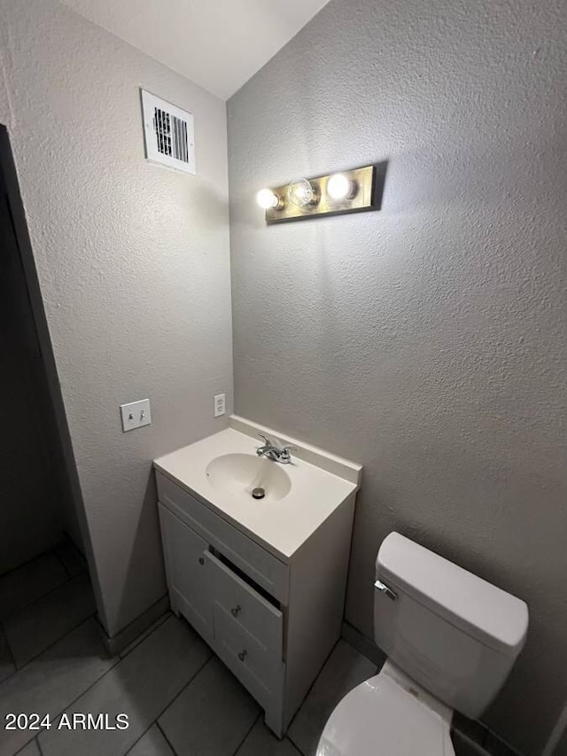 bathroom with tile patterned floors, vanity, and toilet