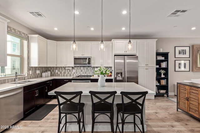 820 N 8th Ave Unit 14, Phoenix, AZ 85007 - kitchen with appliances with stainless steel finishes, white cabinets, light countertops, backsplash, and recessed lighting