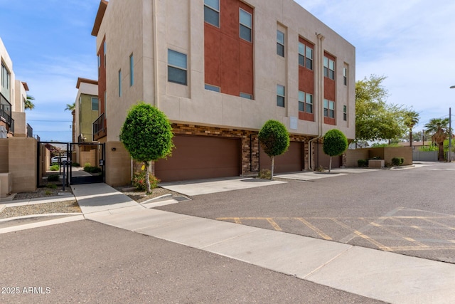 820 N 8th Ave Unit 14, Phoenix, AZ 85007 - view of building exterior featuring an attached garage and concrete driveway