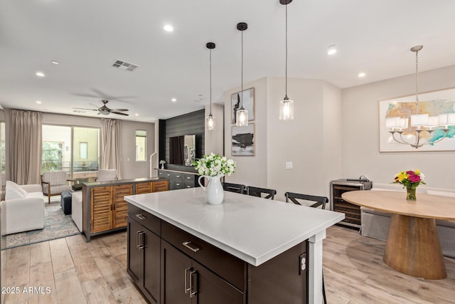 820 N 8th Ave Unit 14, Phoenix, AZ 85007 - kitchen featuring a kitchen island, light wood-type flooring, open floor plan, a chandelier, and recessed lighting