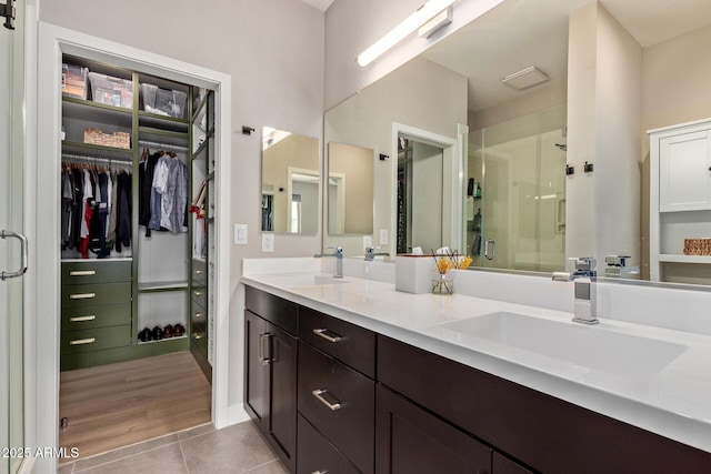 820 N 8th Ave Unit 14, Phoenix, AZ 85007 - full bathroom with double vanity, a stall shower, a spacious closet, and tile patterned floors