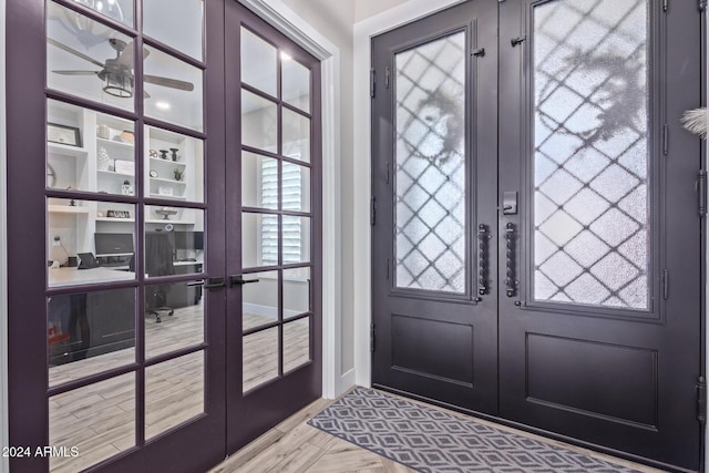 entryway featuring ceiling fan, french doors, a healthy amount of sunlight, and light hardwood / wood-style flooring