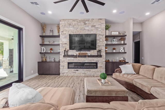 living room with a fireplace and light wood-type flooring