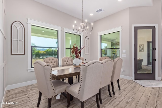 dining room featuring an inviting chandelier and light wood-type flooring