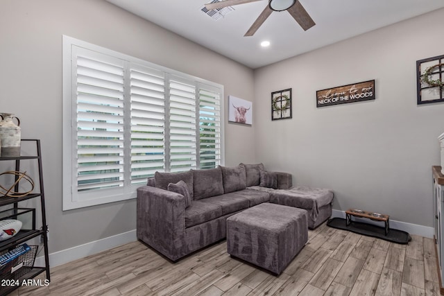 living room with ceiling fan and light wood-type flooring