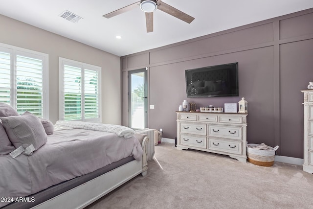 bedroom with access to outside, ceiling fan, and light carpet