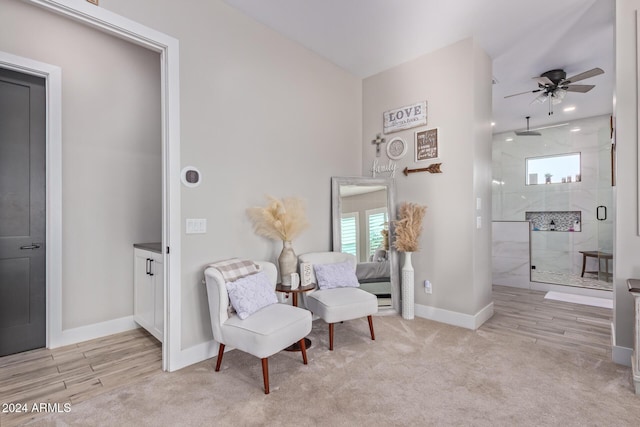 sitting room with light hardwood / wood-style flooring and ceiling fan