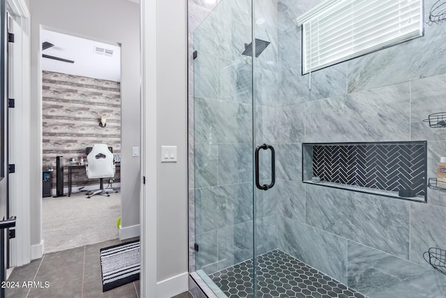 bathroom featuring a shower with door and tile patterned flooring