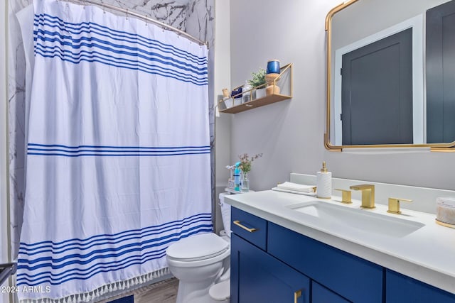 bathroom with curtained shower, toilet, vanity, and hardwood / wood-style flooring