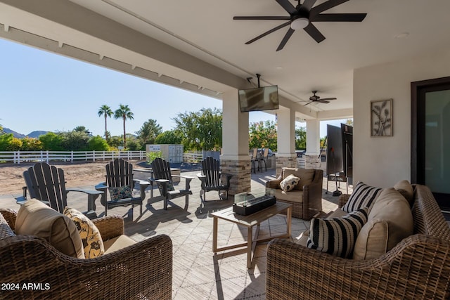 view of patio with an outdoor living space and ceiling fan