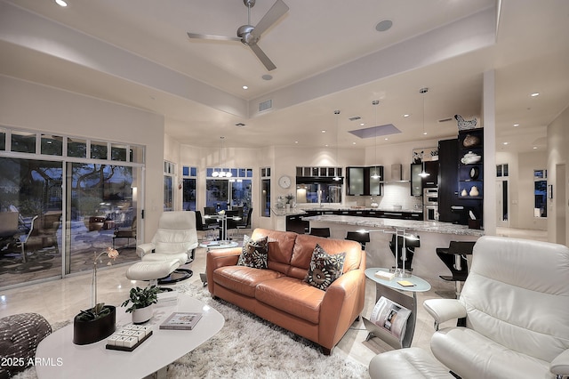 living area featuring a ceiling fan, recessed lighting, and visible vents
