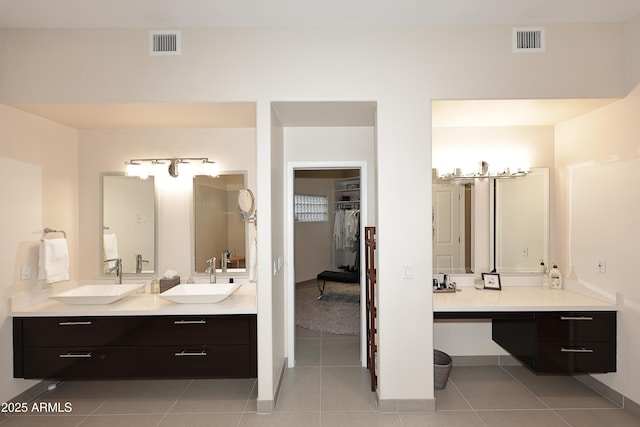 full bathroom featuring a sink, double vanity, and visible vents