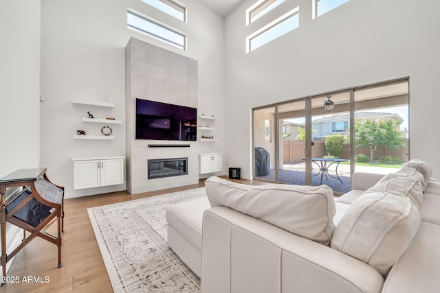 3417 E Los Gatos Dr, Phoenix, AZ 85050 - living area with a high ceiling, a large fireplace, and light wood-style flooring