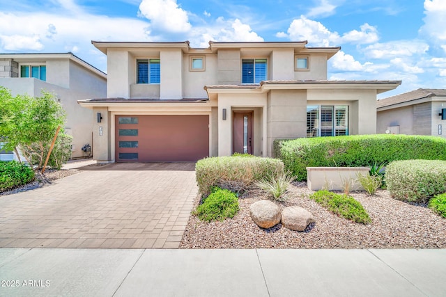 3417 E Los Gatos Dr, Phoenix, AZ 85050 - prairie-style house featuring stucco siding, decorative driveway, and a garage