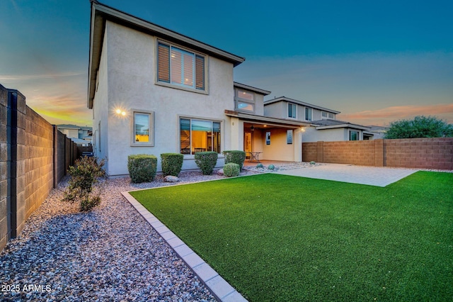 3417 E Los Gatos Dr, Phoenix, AZ 85050 - back of house at dusk featuring a patio, stucco siding, and a fenced backyard