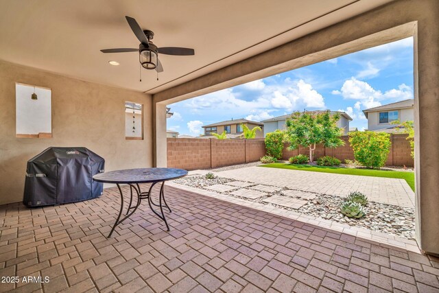 3417 E Los Gatos Dr, Phoenix, AZ 85050 - fenced backyard with area for grilling, a patio area, and ceiling fan