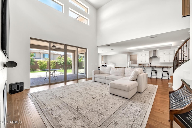 3417 E Los Gatos Dr, Phoenix, AZ 85050 - living room featuring a towering ceiling, wood finished floors, stairs, and a ceiling fan
