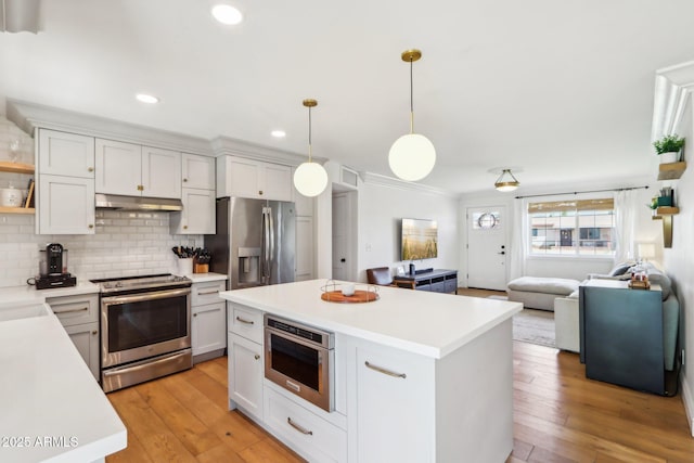 653 W Inglewood St, Mesa, AZ 85201 - kitchen featuring backsplash, under cabinet range hood, light countertops, open floor plan, and stainless steel appliances