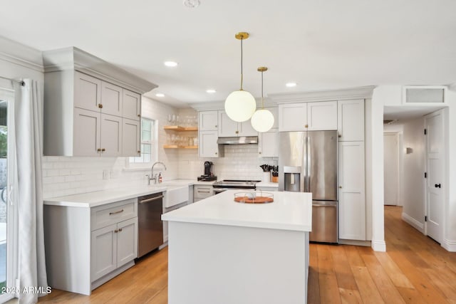 653 W Inglewood St, Mesa, AZ 85201 - kitchen with light countertops, decorative backsplash, under cabinet range hood, and stainless steel appliances