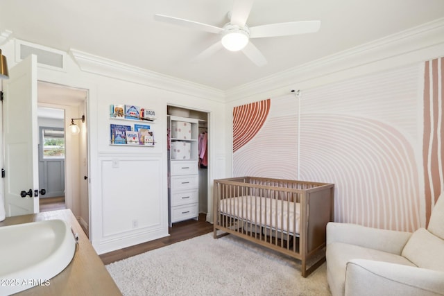 653 W Inglewood St, Mesa, AZ 85201 - bedroom featuring ceiling fan, wood finished floors, a sink, a crib, and ornamental molding