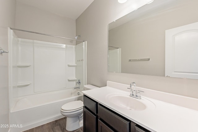 full bathroom featuring toilet, vanity, wood-type flooring, and shower / washtub combination