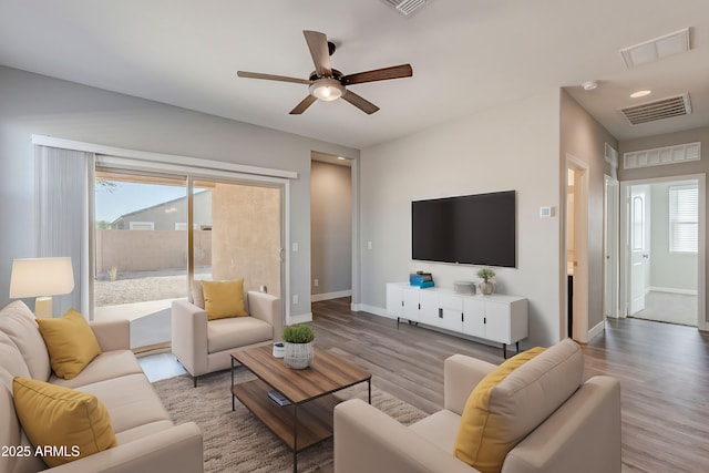 living room featuring ceiling fan and light hardwood / wood-style flooring