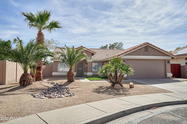 view of front of property featuring stucco siding, fence, a garage, driveway, and a tiled roof