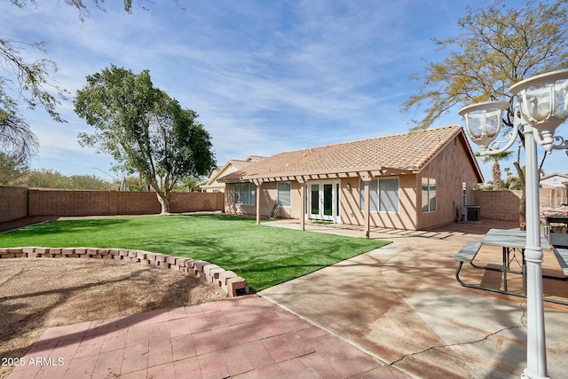 back of property with a patio area, a fenced backyard, a tile roof, and cooling unit