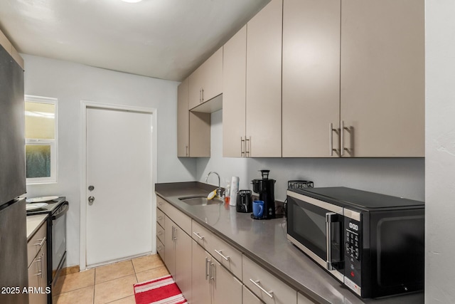 1605 W Osborn Rd, Phoenix, AZ 85015 - kitchen with appliances with stainless steel finishes, light tile patterned flooring, and dark countertops