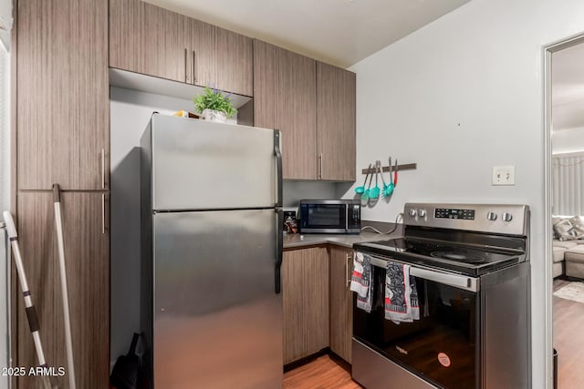 1605 W Osborn Rd, Phoenix, AZ 85015 - kitchen with appliances with stainless steel finishes and light wood-style floors