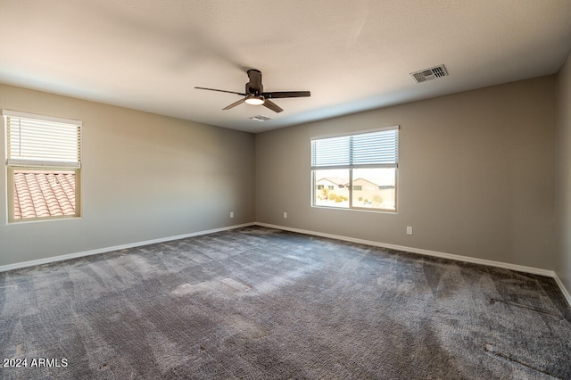 empty room with ceiling fan and carpet flooring