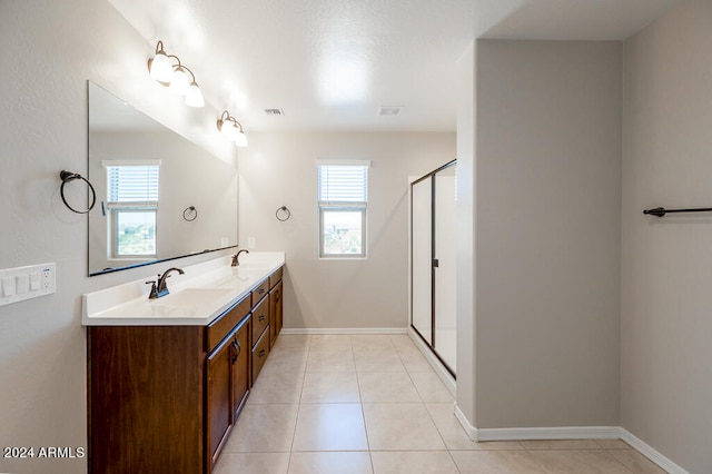 bathroom with vanity, an enclosed shower, and tile patterned floors