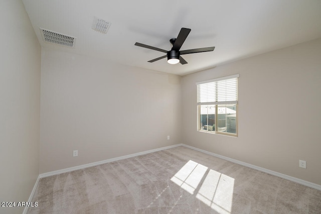 carpeted spare room featuring ceiling fan