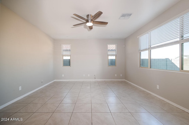 tiled empty room with ceiling fan