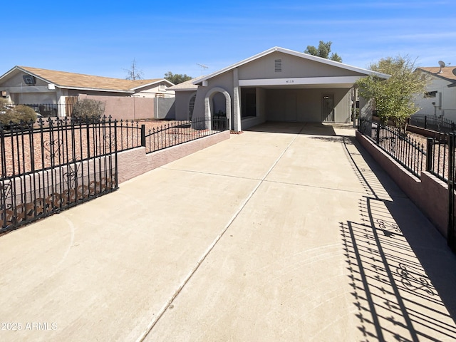 exterior space featuring a fenced front yard, driveway, and stucco siding