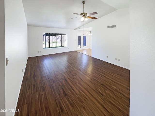 unfurnished room featuring visible vents, dark wood-type flooring, baseboards, ceiling fan, and lofted ceiling