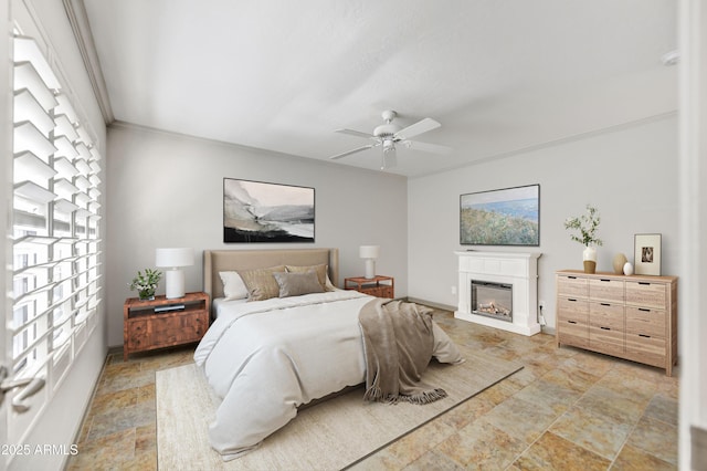 37801 N Cave Creek Rd Unit 13, Cave Creek, AZ 85331 - bedroom featuring stone finish floors, a glass covered fireplace, and ceiling fan