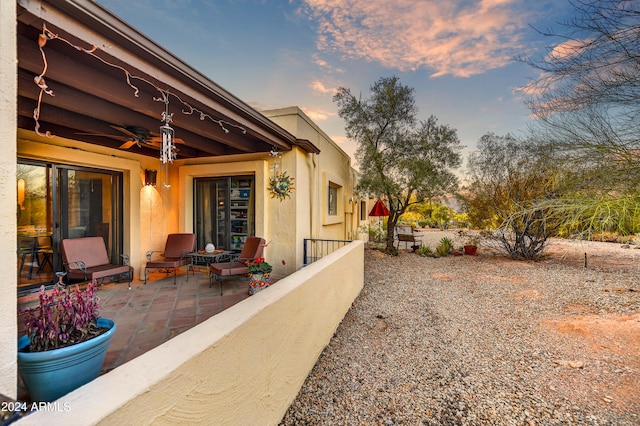 37801 N Cave Creek Rd Unit 13, Cave Creek, AZ 85331 - patio terrace at dusk featuring a patio and ceiling fan