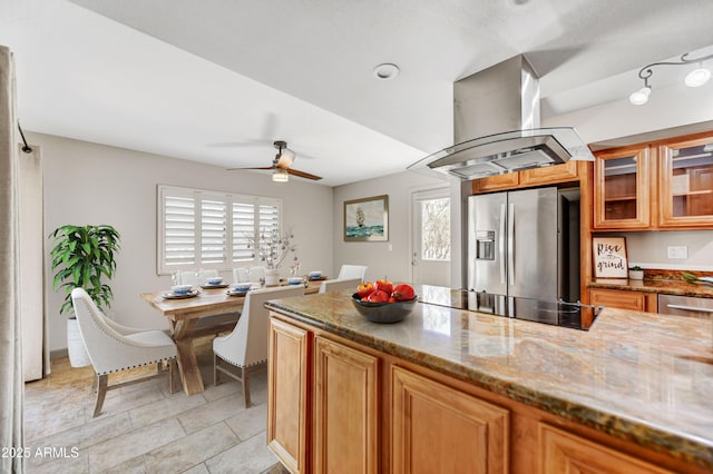 37801 N Cave Creek Rd Unit 13, Cave Creek, AZ 85331 - kitchen featuring stainless steel refrigerator with ice dispenser, black electric cooktop, island range hood, and stone countertops