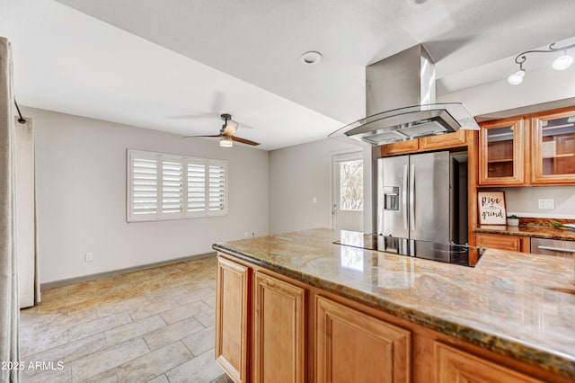 37801 N Cave Creek Rd Unit 13, Cave Creek, AZ 85331 - kitchen featuring stainless steel fridge with ice dispenser, black electric cooktop, island range hood, a ceiling fan, and stone counters