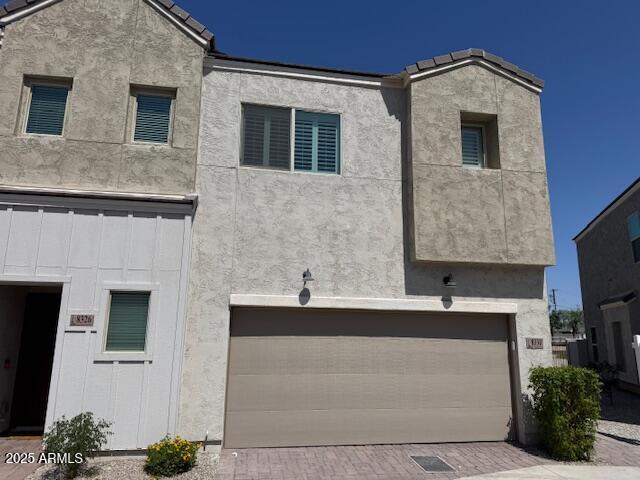 8330 N 22nd Ln, Phoenix, AZ 85021 - view of front of home with stucco siding, a garage, and decorative driveway