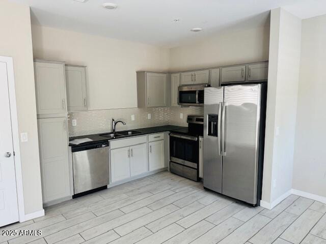 8330 N 22nd Ln, Phoenix, AZ 85021 - kitchen featuring stainless steel appliances, wood tiled floors, dark countertops, tasteful backsplash, and gray cabinets