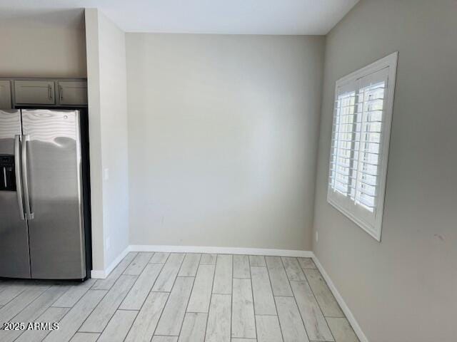 8330 N 22nd Ln, Phoenix, AZ 85021 - unfurnished dining area featuring light wood-style floors and baseboards