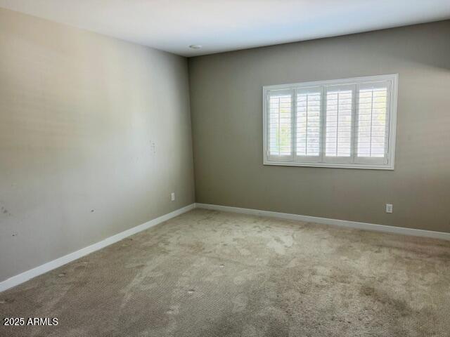 8330 N 22nd Ln, Phoenix, AZ 85021 - spare room featuring carpet floors and baseboards